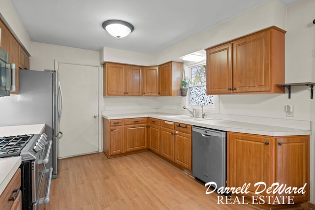 kitchen featuring sink, stainless steel appliances, and light wood-type flooring