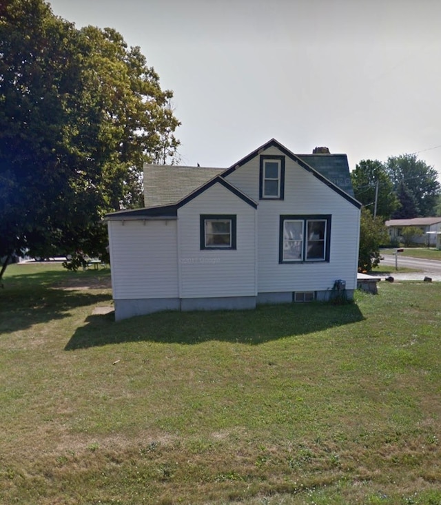 3386 W Hobson Ave, Flint, MI 48504 - view of home's exterior featuring a chimney and a lawn