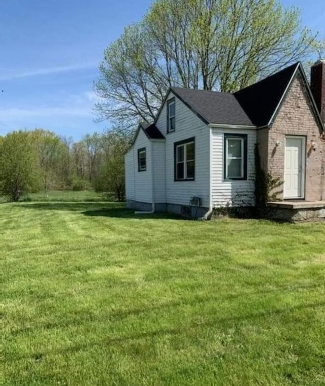 view of side of property with a lawn