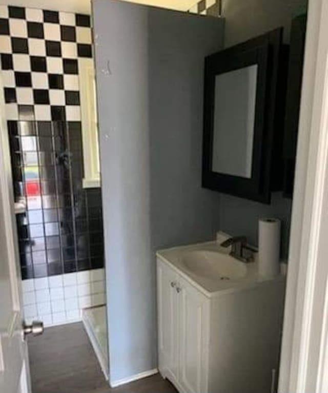 bathroom with vanity and tile walls