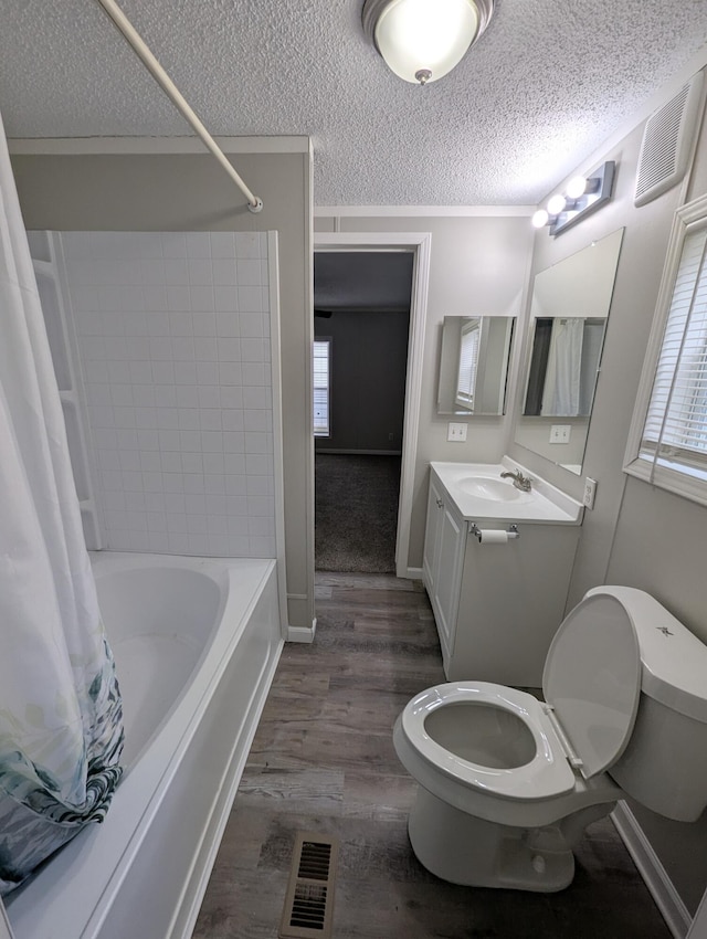 full bathroom featuring a textured ceiling, a wealth of natural light, wood-type flooring, and shower / bath combo