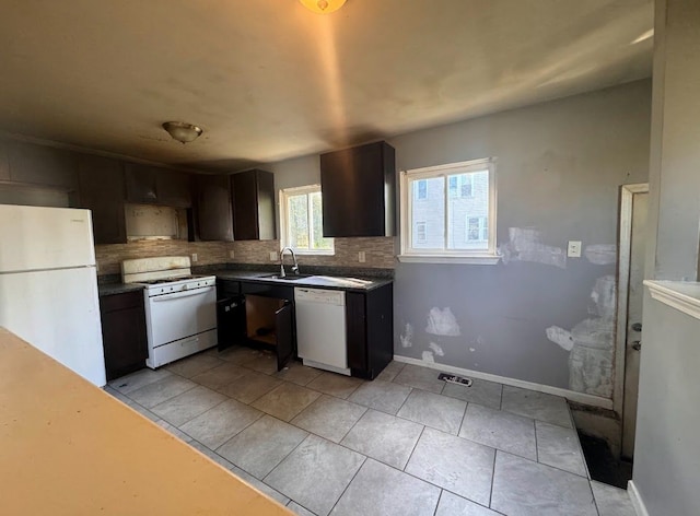 kitchen with white appliances, backsplash, sink, dark brown cabinets, and light tile patterned flooring