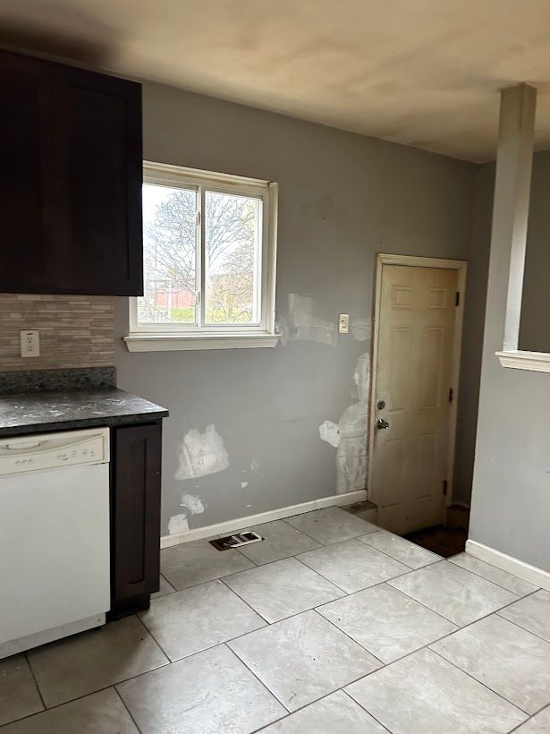 bathroom with decorative backsplash and tile patterned floors