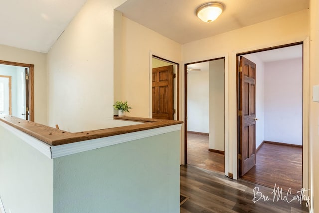 corridor with dark hardwood / wood-style floors