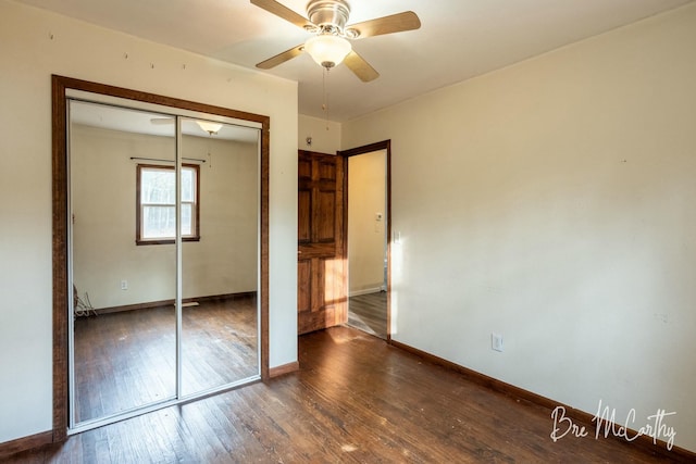 unfurnished bedroom with dark hardwood / wood-style flooring, a closet, and ceiling fan