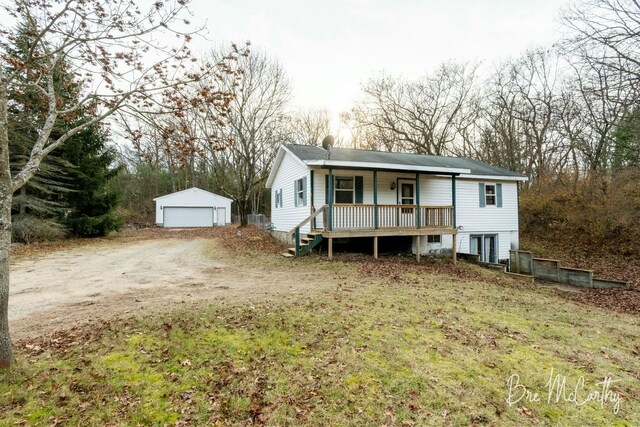 view of front of property with an outbuilding, a porch, and a garage