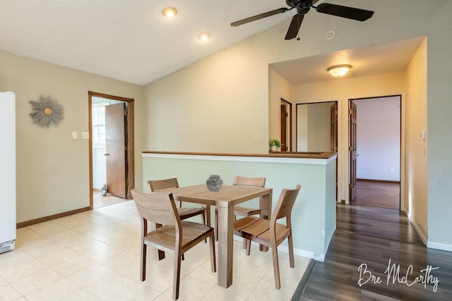 dining space with ceiling fan, hardwood / wood-style floors, and lofted ceiling