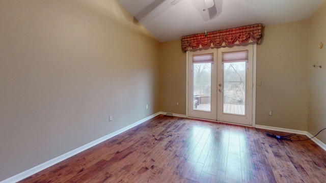 unfurnished room featuring hardwood / wood-style floors, ceiling fan, and french doors