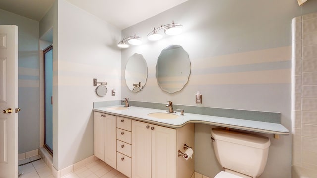 bathroom featuring toilet, vanity, tile patterned floors, and an enclosed shower