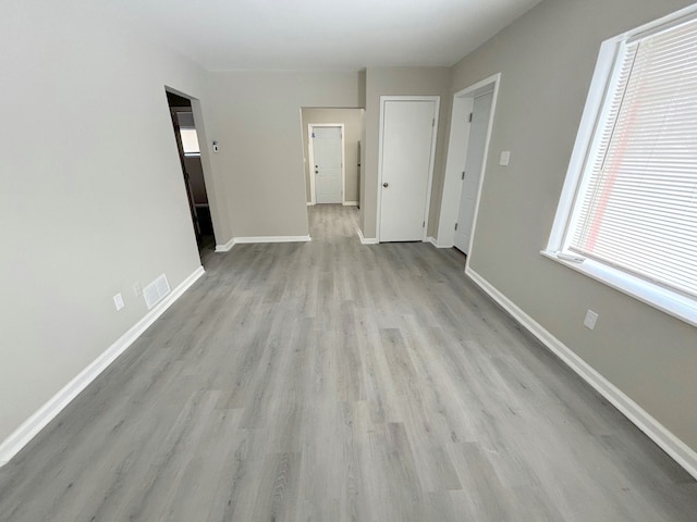 empty room with light hardwood / wood-style flooring