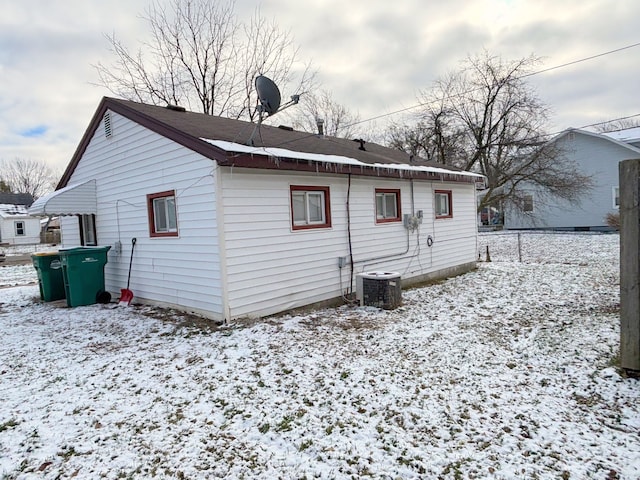 snow covered house with cooling unit