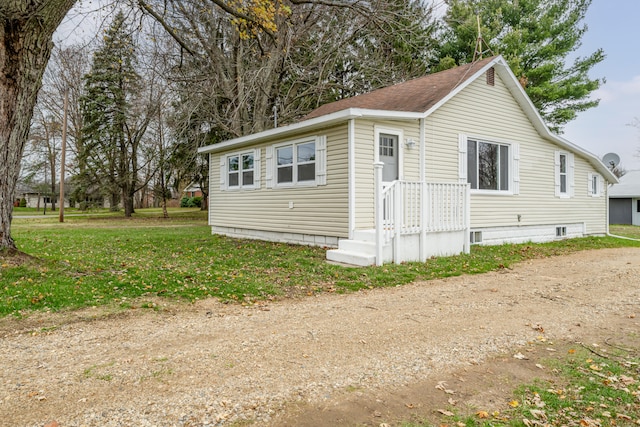 view of property exterior with a lawn