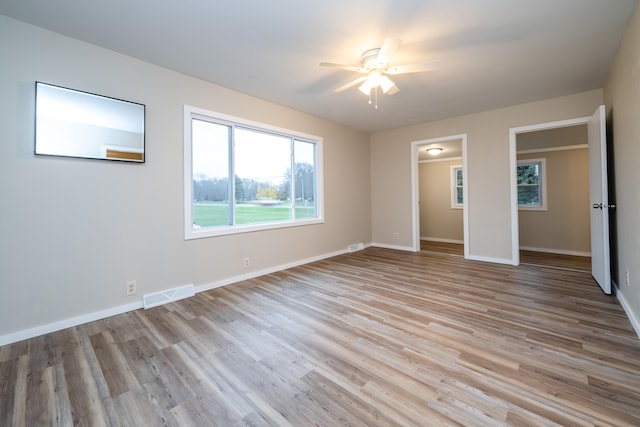 unfurnished bedroom with light wood-type flooring and ceiling fan