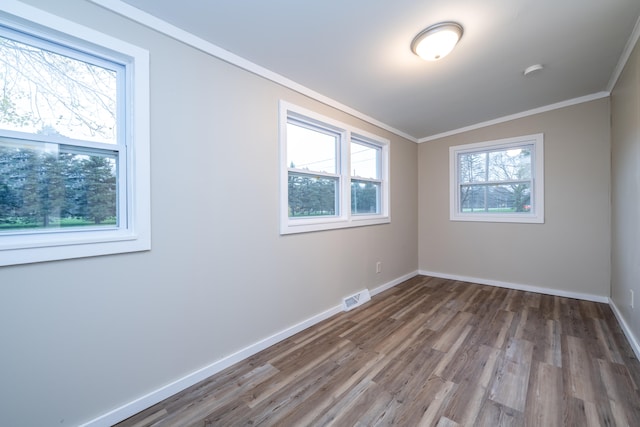 unfurnished room with hardwood / wood-style floors and a healthy amount of sunlight