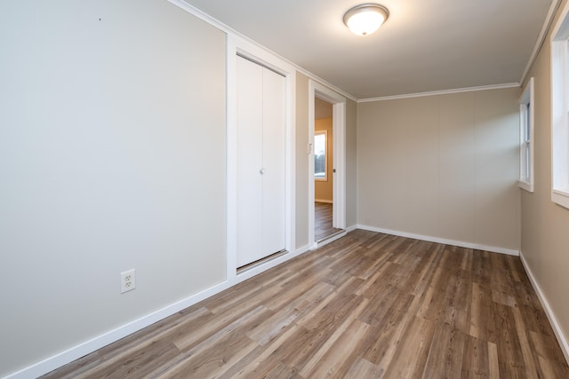 unfurnished room featuring hardwood / wood-style flooring and ornamental molding