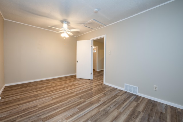 unfurnished room with a textured ceiling, light wood-type flooring, ceiling fan, and ornamental molding