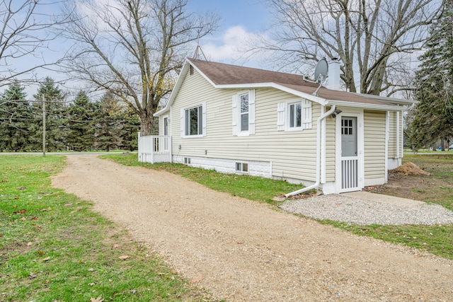 view of property exterior with a lawn