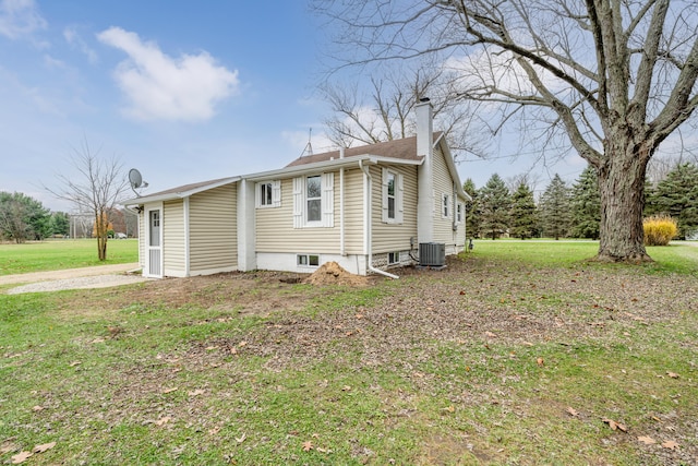 view of home's exterior with central air condition unit and a lawn