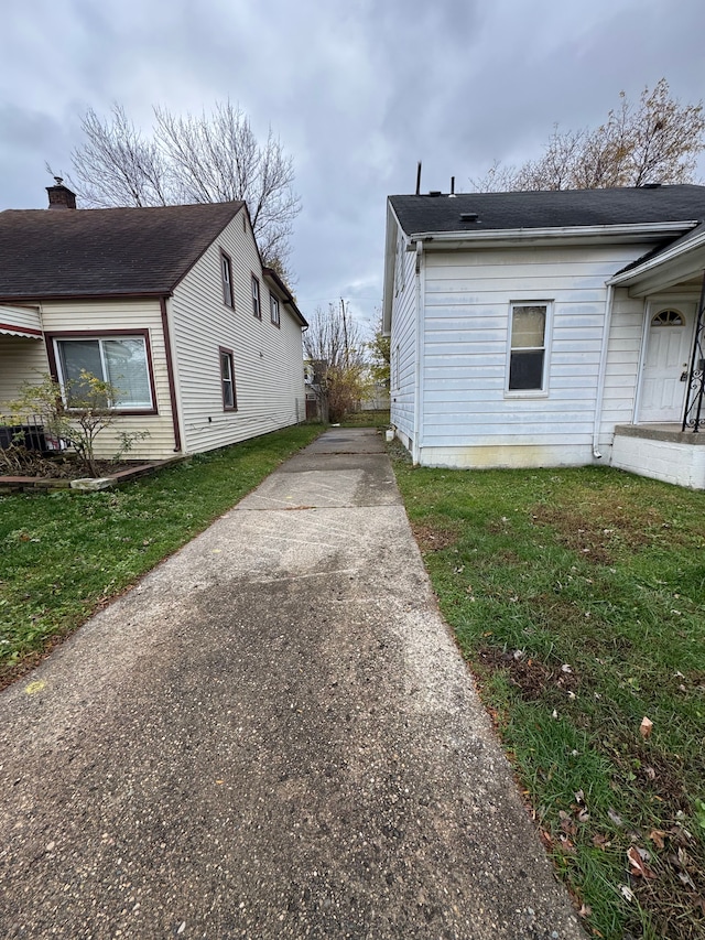 view of side of home with a yard