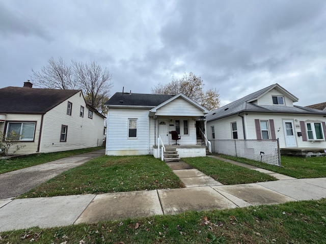 bungalow-style house with a front lawn