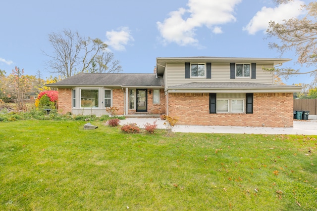 split level home with a front lawn