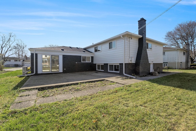 rear view of property with a yard, a patio area, and central AC