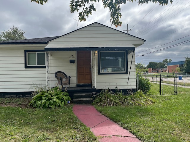 bungalow-style home featuring a front yard