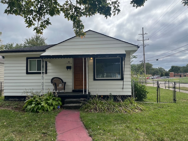 bungalow-style home with a front lawn