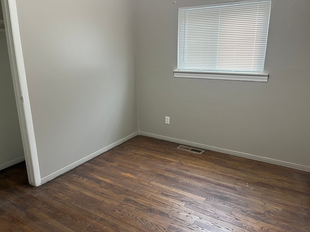 spare room featuring dark hardwood / wood-style floors