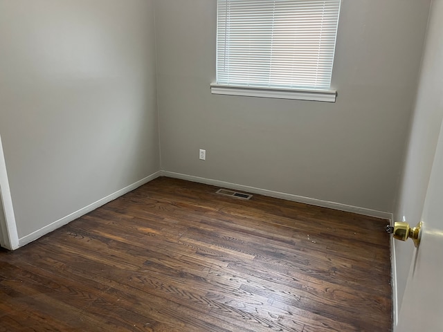 unfurnished room featuring dark hardwood / wood-style flooring