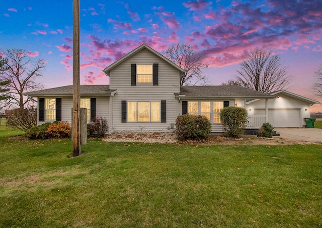 view of property featuring a lawn and a garage