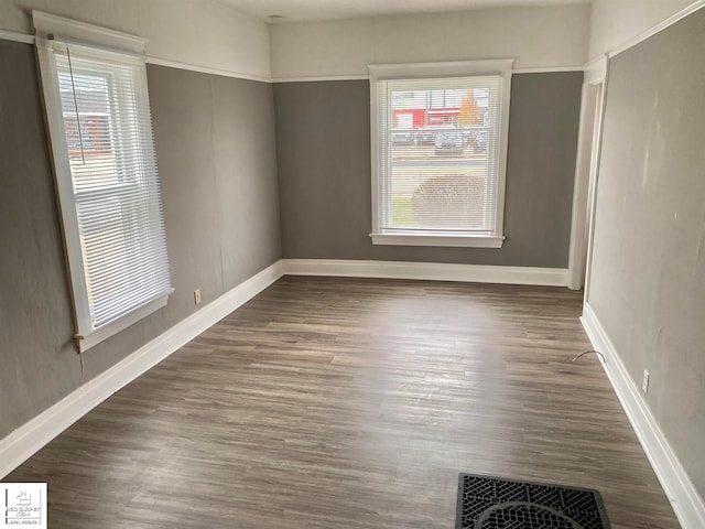 spare room featuring dark hardwood / wood-style floors