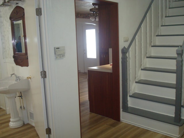 staircase with wood-type flooring