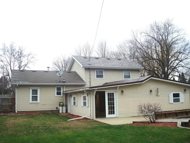 back of house with a patio area and a yard