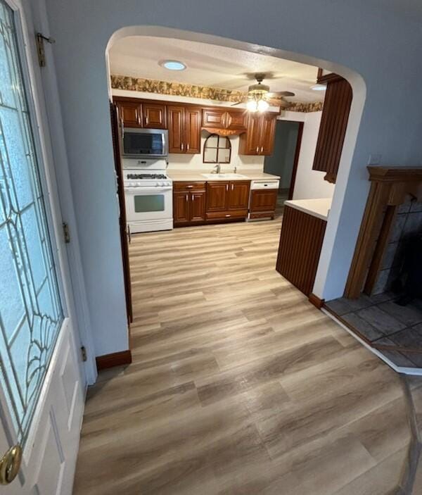 kitchen featuring ceiling fan, light hardwood / wood-style floors, and white range oven