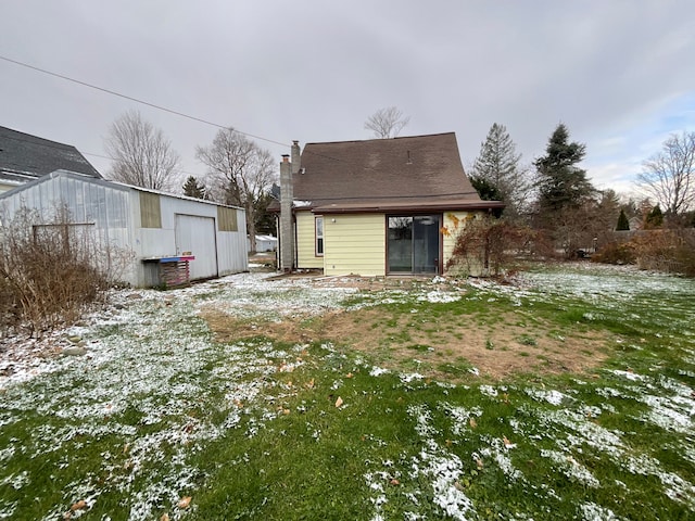 snow covered property with an outdoor structure