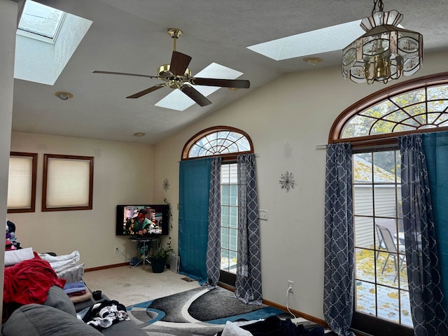 living room featuring carpet, ceiling fan with notable chandelier, a textured ceiling, and vaulted ceiling