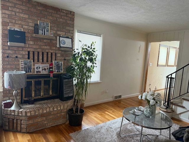 living room featuring hardwood / wood-style floors and a textured ceiling