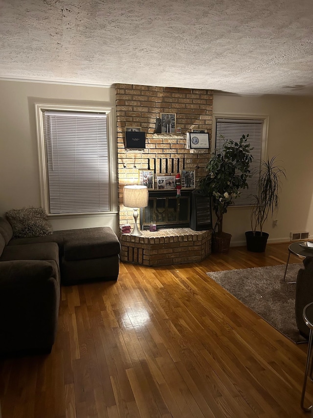 living room with hardwood / wood-style floors and a textured ceiling