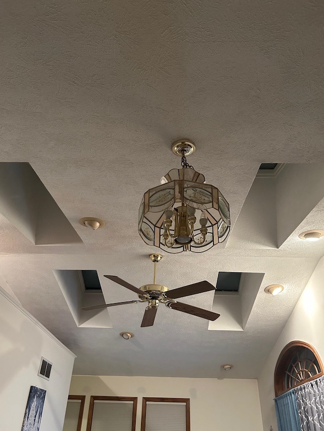 details with ceiling fan and a textured ceiling