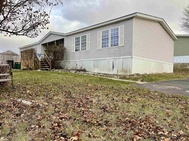 view of side of property with a yard