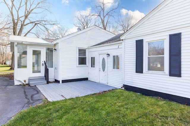 view of front facade with a sunroom and a front lawn