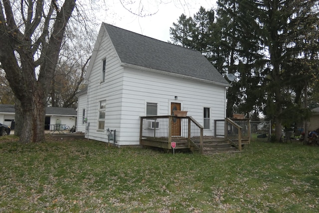 back of property with a yard and a deck