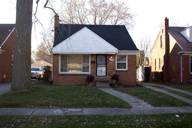 bungalow-style home featuring a front yard