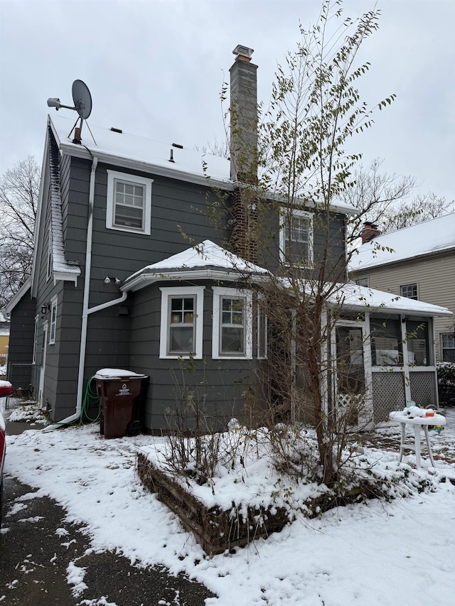 view of snow covered back of property