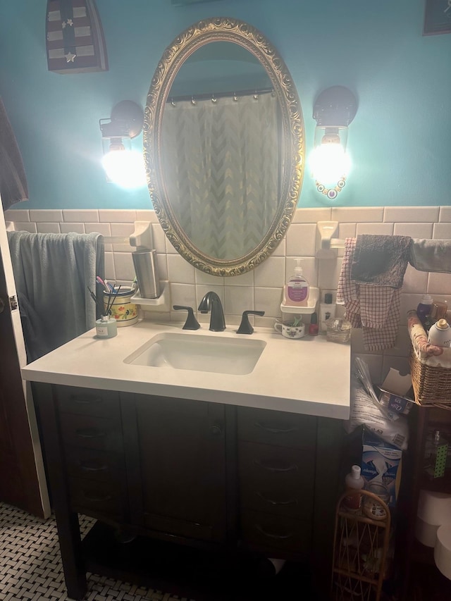 bathroom with vanity and tile walls