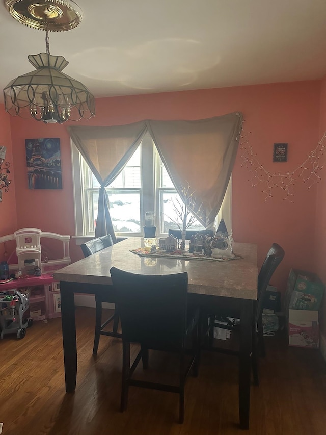 dining room featuring hardwood / wood-style flooring and an inviting chandelier