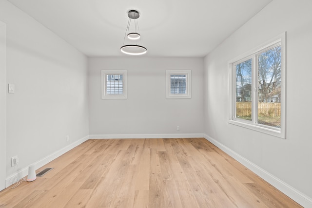 unfurnished room with light hardwood / wood-style floors and a wealth of natural light