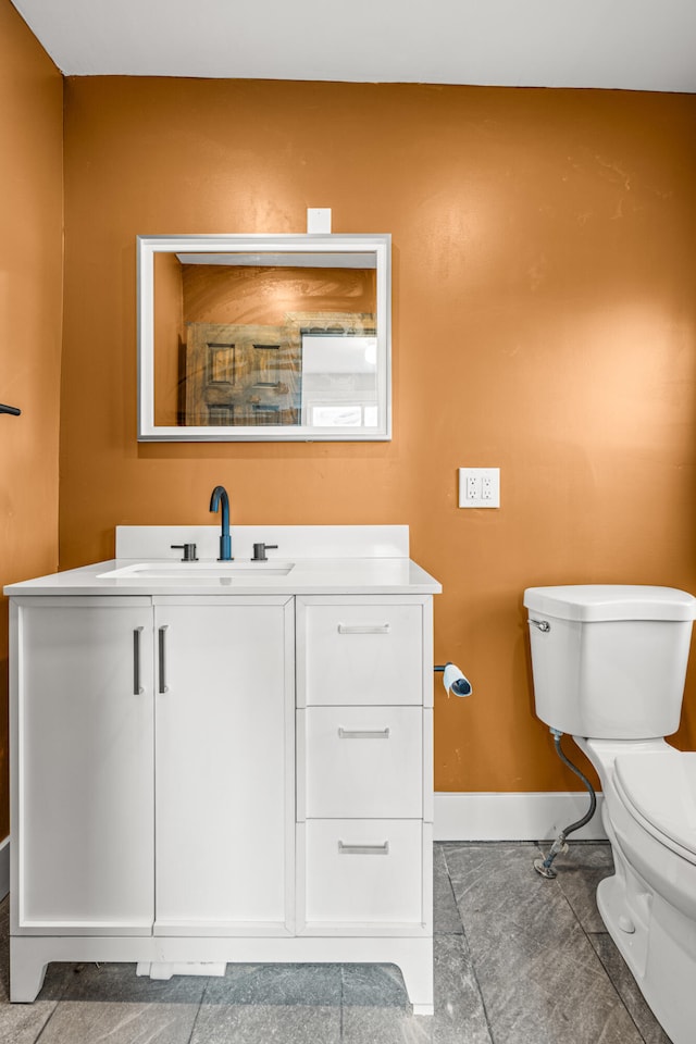 bathroom featuring tile patterned floors, vanity, and toilet