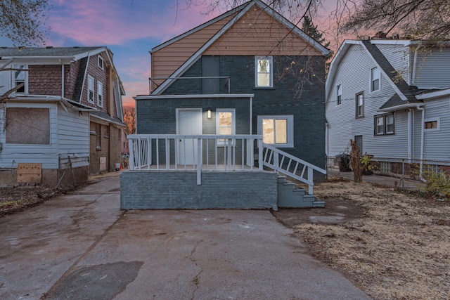 view of back house at dusk